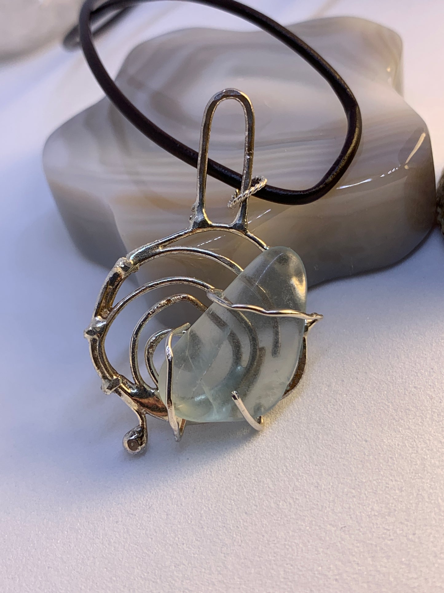 Unique Abstract Fluorite Sterling Silver Pendant. This piece is 3 inches tall and has a natural fluorite stone in center. This stone is soft polished and has the look of sea glass, but its fluorite. 